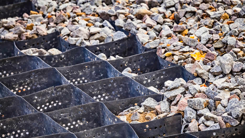 Geogrids filled with multicolored rocks and stones