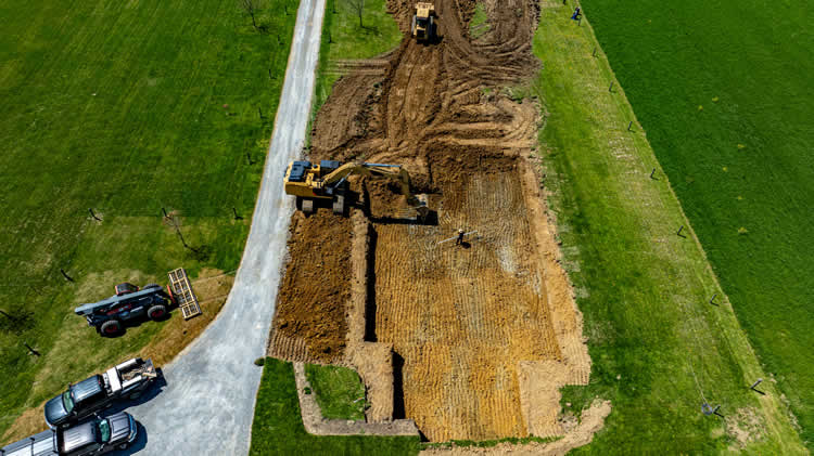 Aerial view of construction site with machinery and trucks